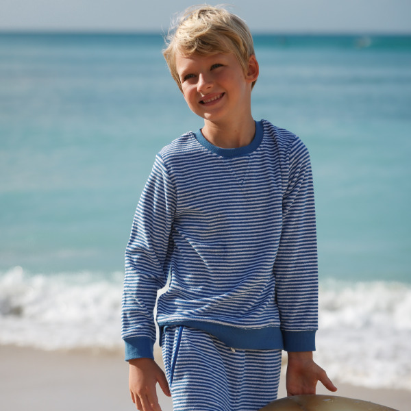 boy wearing minnow terry sweatshirt on the beach