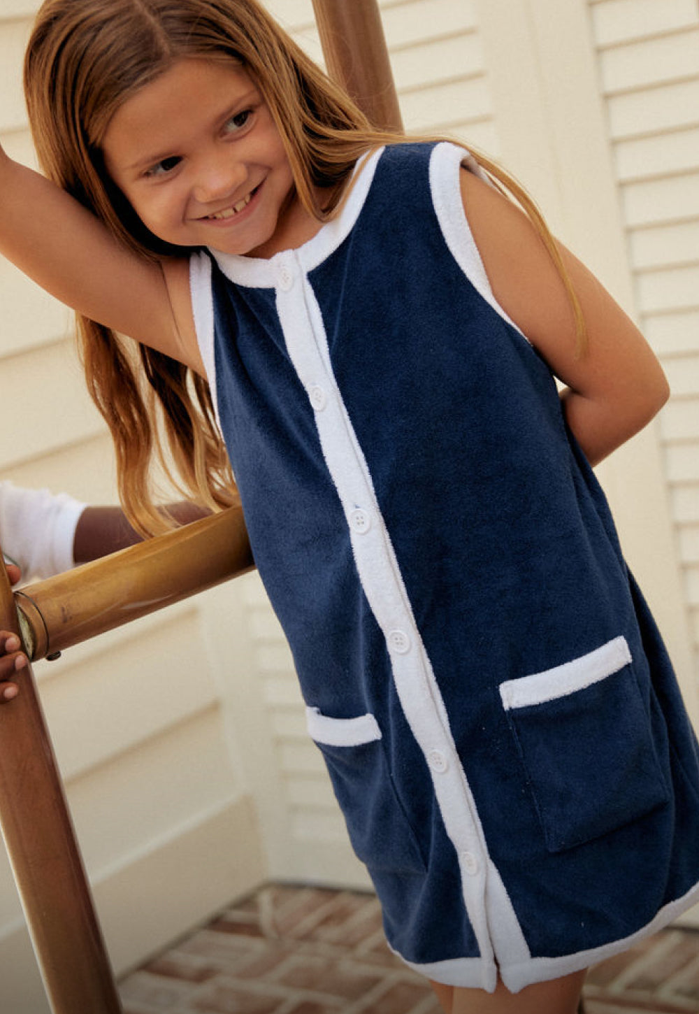 girl wearing navy french terry button down dress