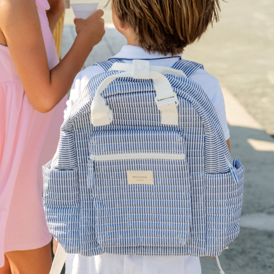 boy carrying minnow stripe backpack